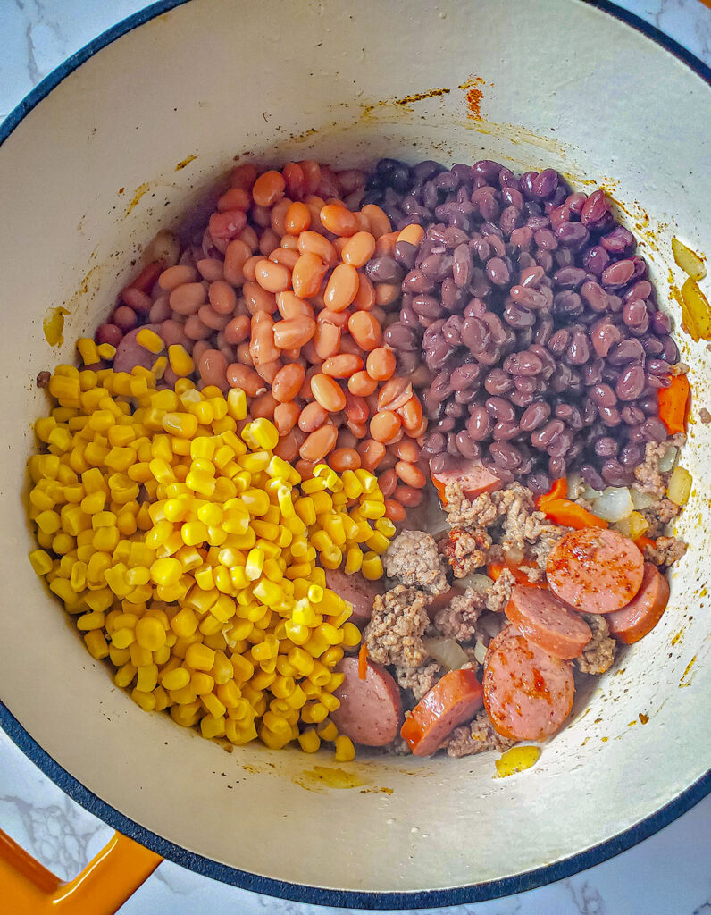 Beans and corn are added to the pot. 