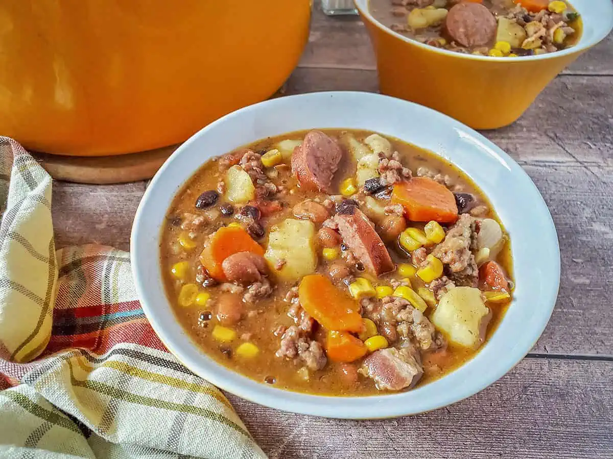 A bowlful of cowboy stew in a blue bowl.