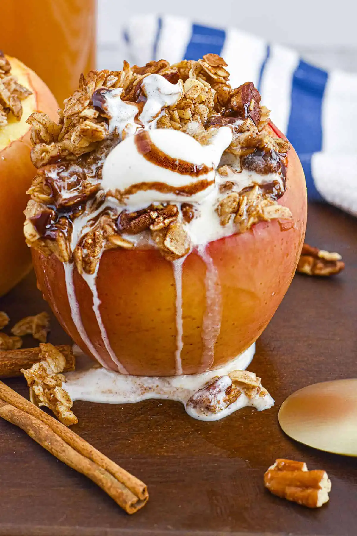 A maple cinnamon baked apple with melting ice cream on top with syrup. 