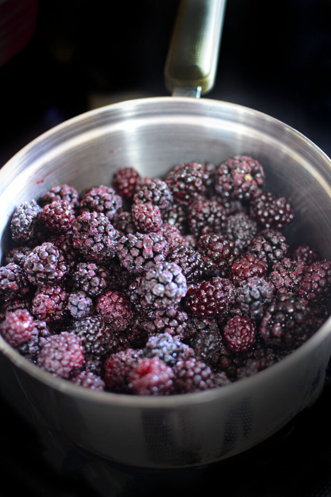 Frozen blackberries in a pot.