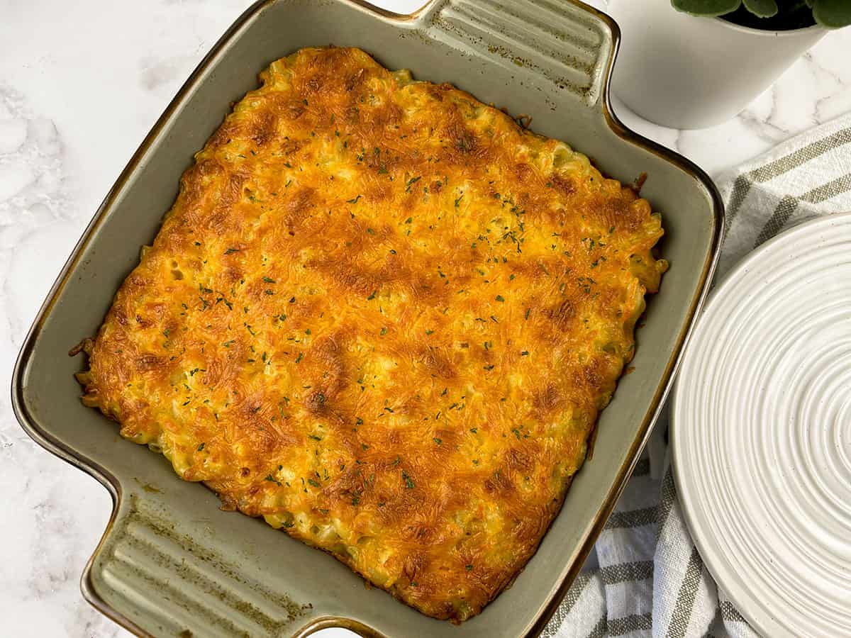 4 cheese macaroni and cheese casserole in a green baking dish.