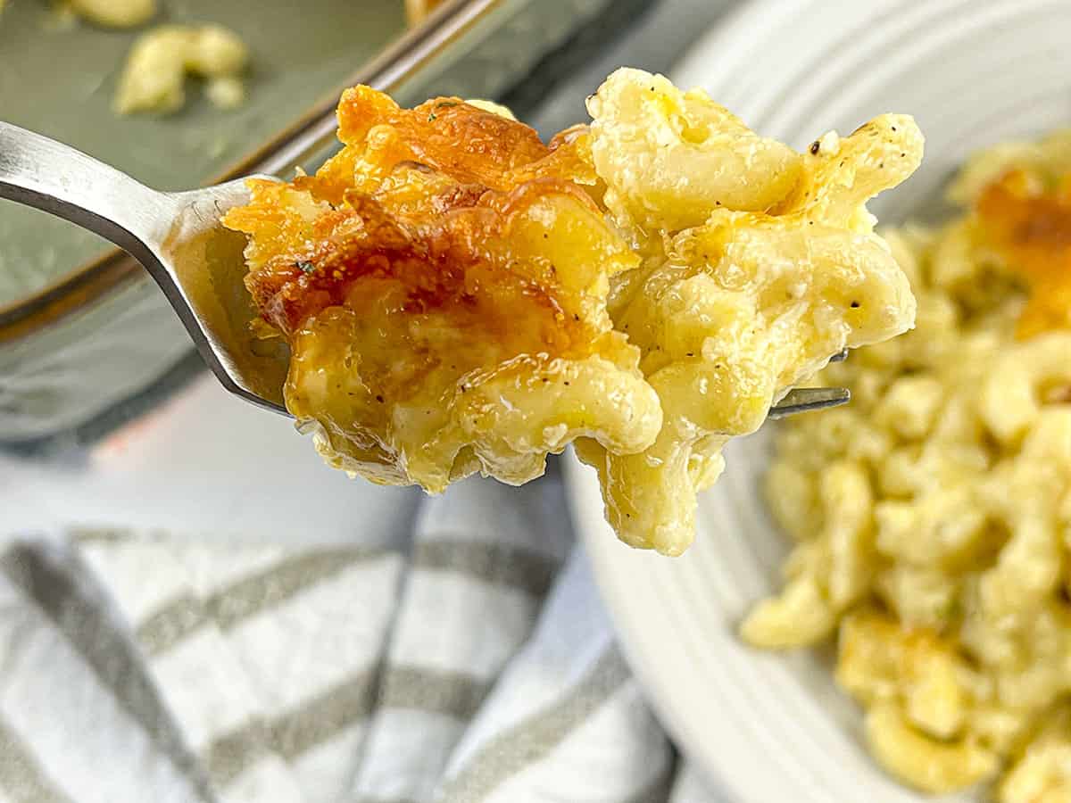 A bite of baked mac and cheese on a fork.