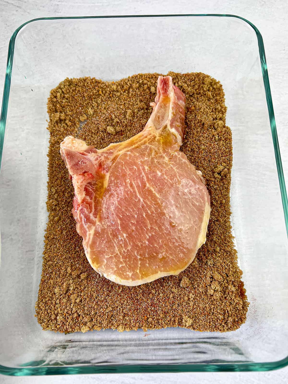 One porkchop in some seasoning.