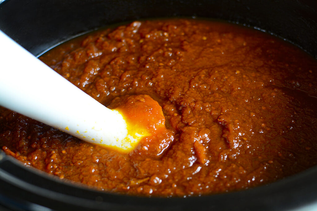 Using an immersion blender to mix up the ketchup.