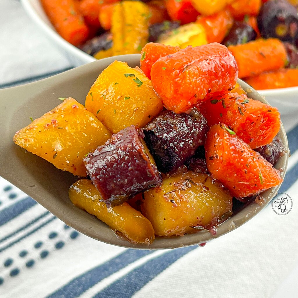 Honey Roasted Rainbow Carrots on a serving spoon.