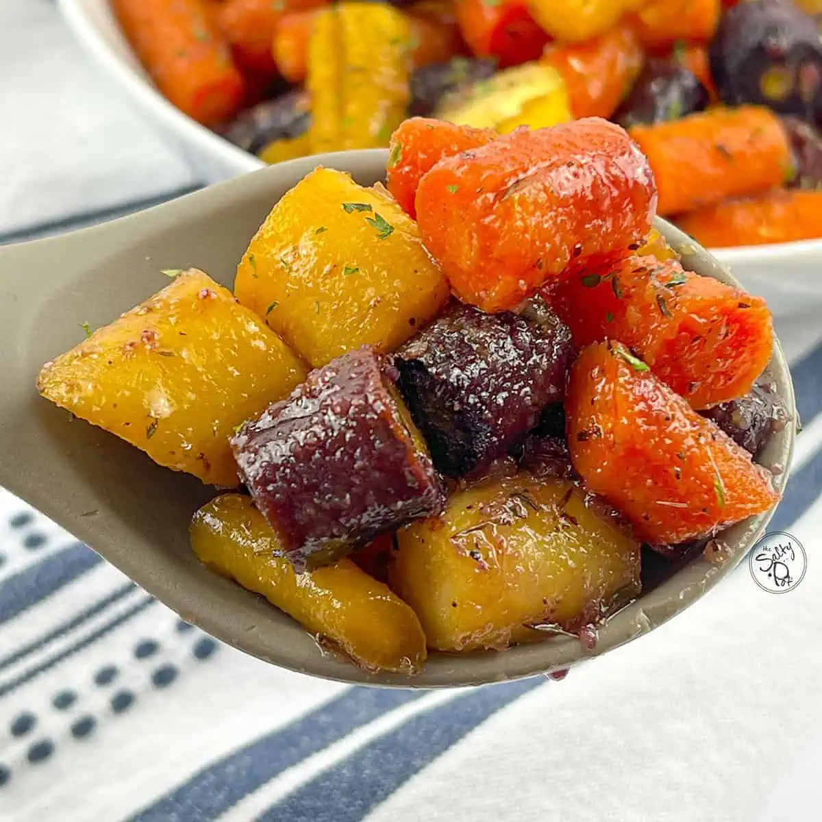 Honey Roasted Rainbow Carrots on a serving spoon.