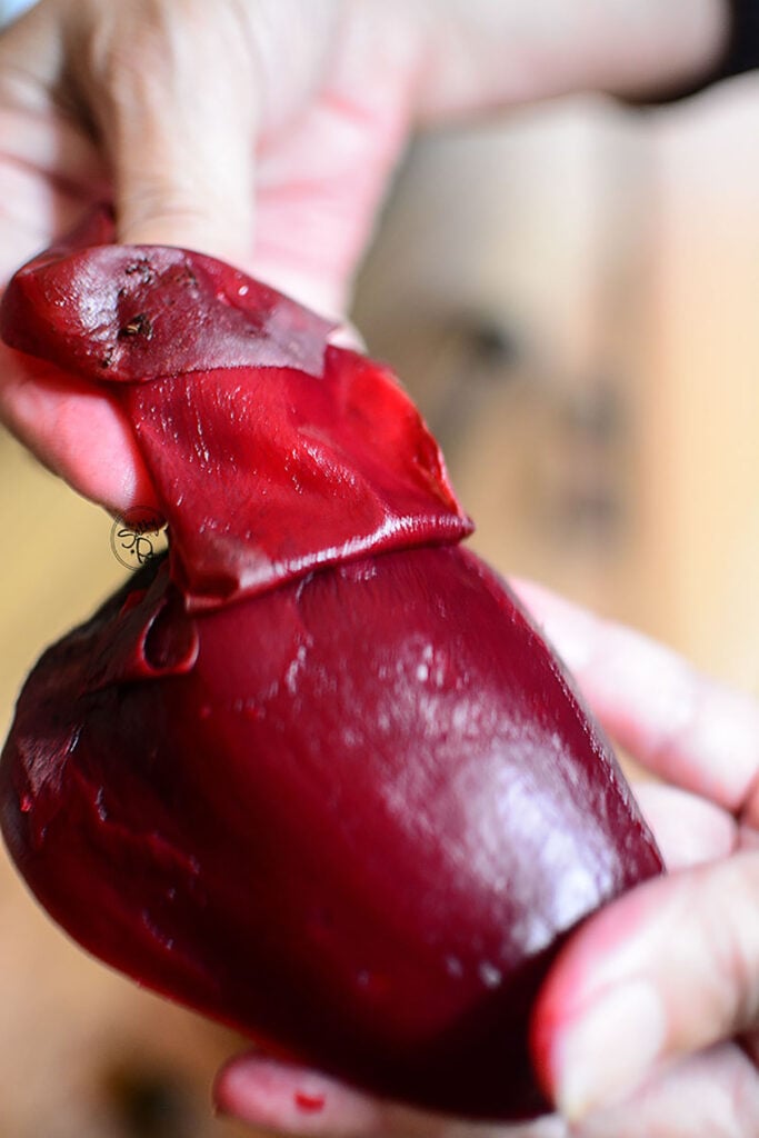 Peeling a cooked beet.