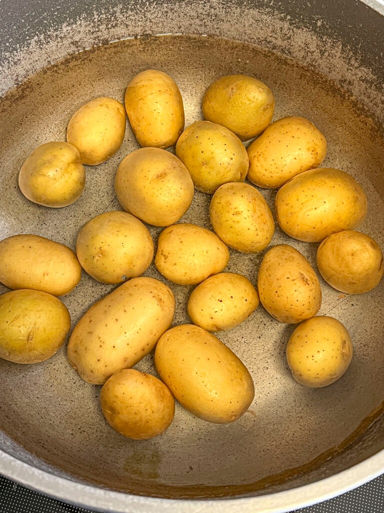 The new potatoes are in a pot, ready to be boiled. 
