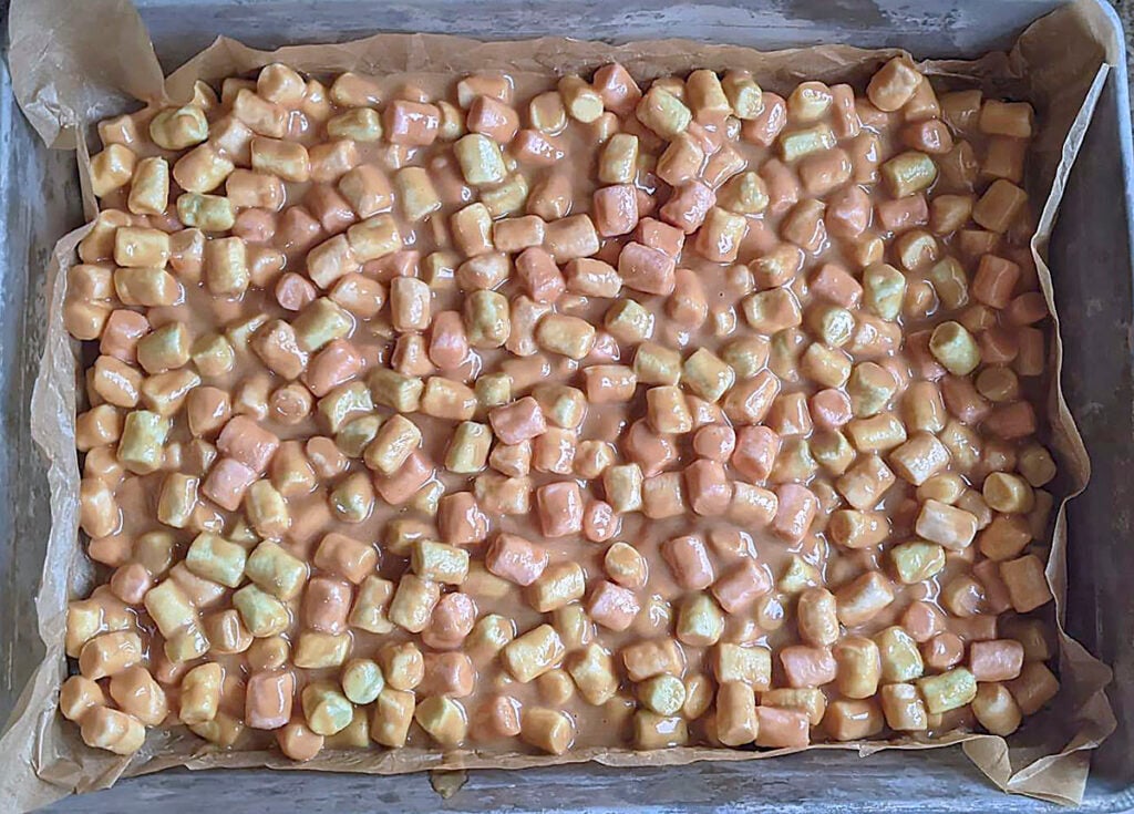 The butterscotch square mixture in a parchment lined pan, ready to set in to squares.