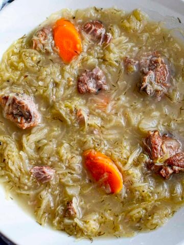 Slow cooker pork neck soup with sauerkraut square image.