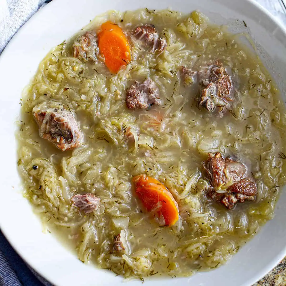 Slow cooker pork neck soup with sauerkraut square image.