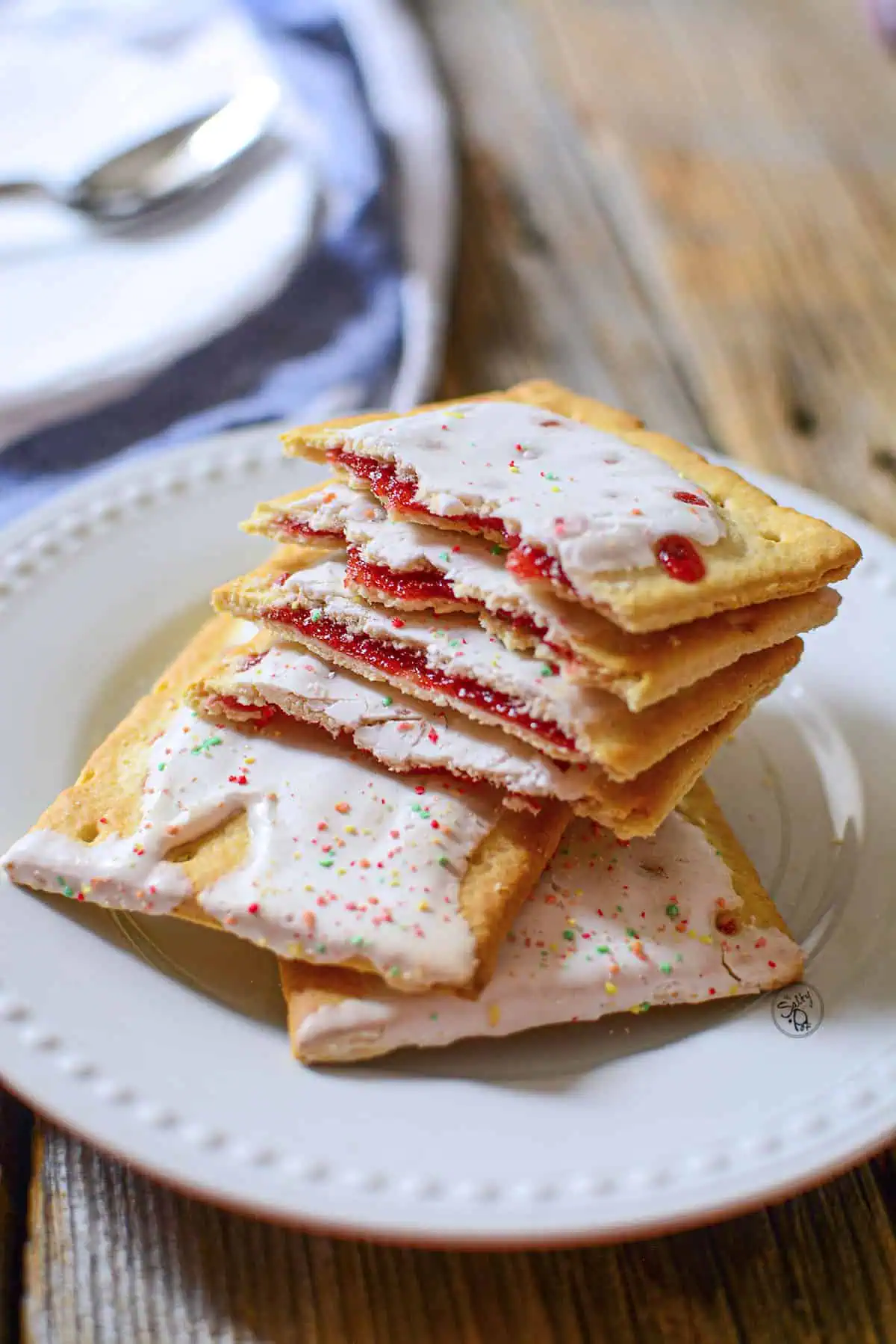 Air fryer pop tarts piled on a white plate.