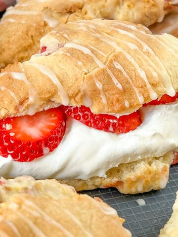 An air fryer scone filled with whipped cream and fresh strawberries.