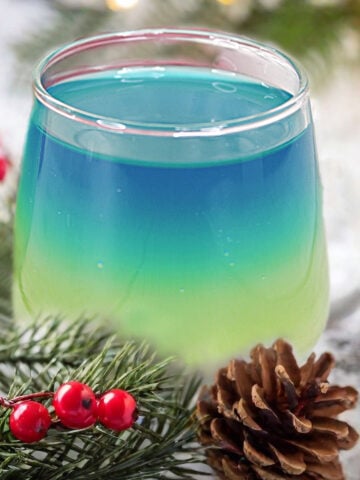 Artic Glow Drop Cocktail in holly branches.