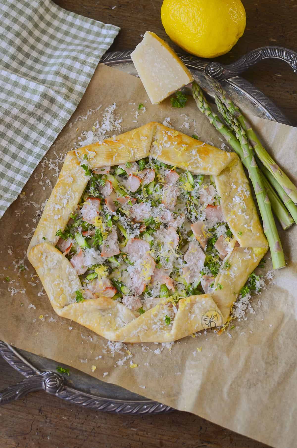 Asparagus and back bacon galette on parchment paper.