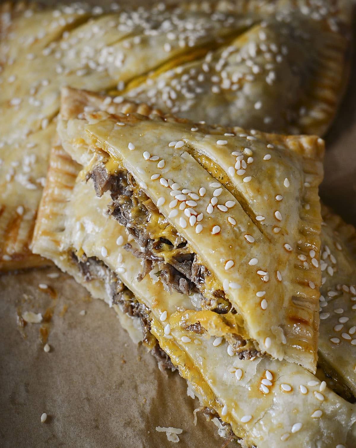 beef and cheddar hand pies cut open to see the filling.