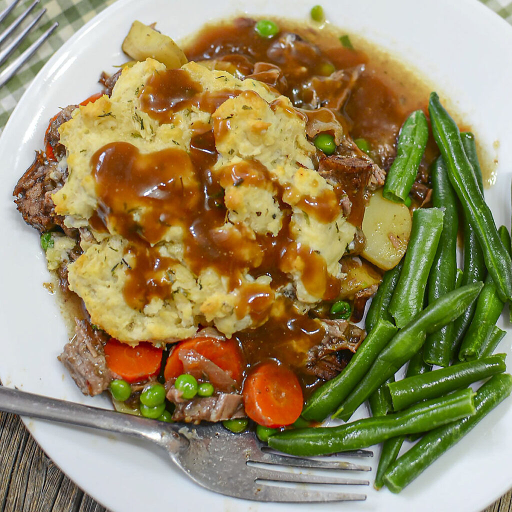 Individual-Beef-Pot-Pie with green beans on a white plate, square-image