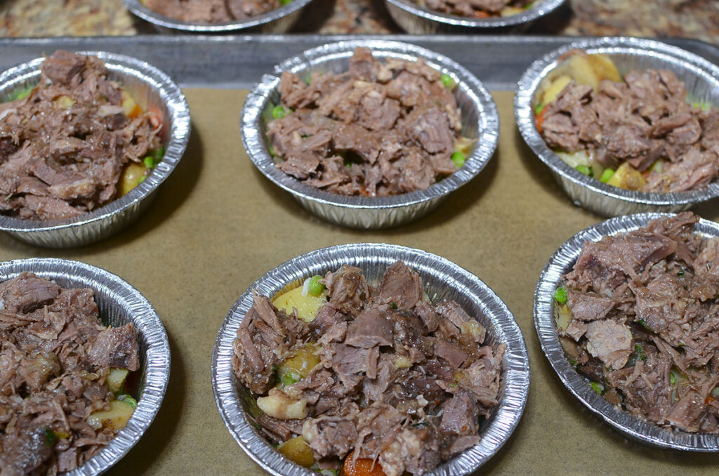 Roast beef added to the top of the ramekins.