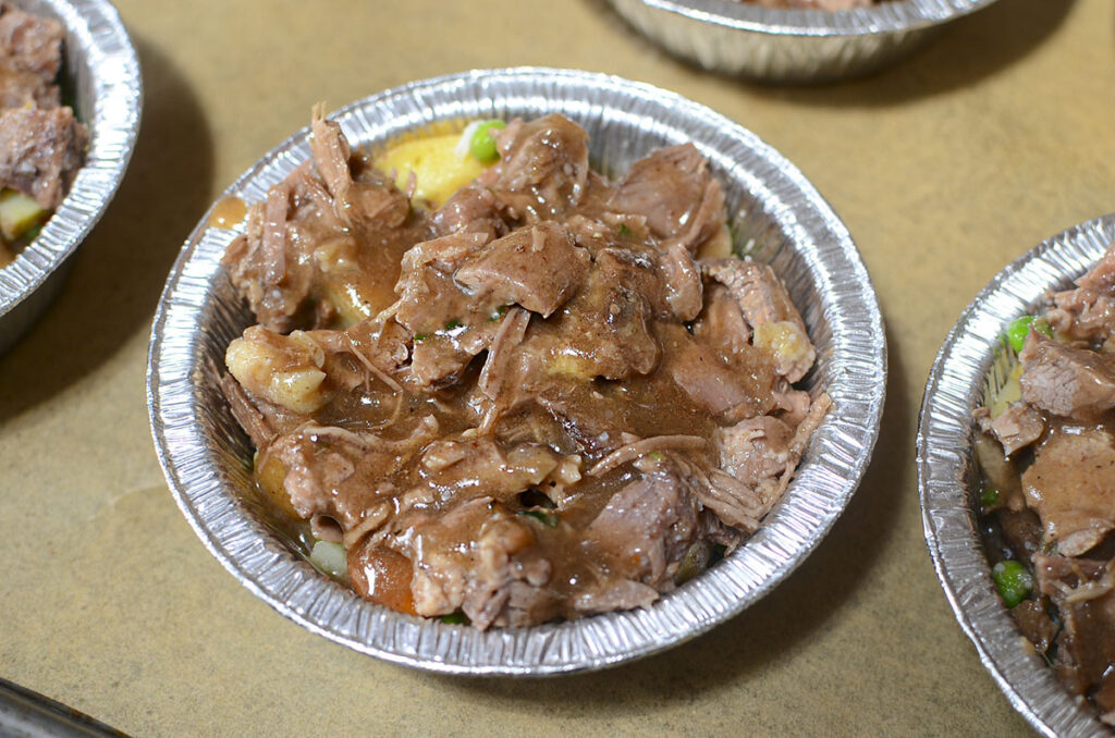 One pot pie drizzled with gravy.