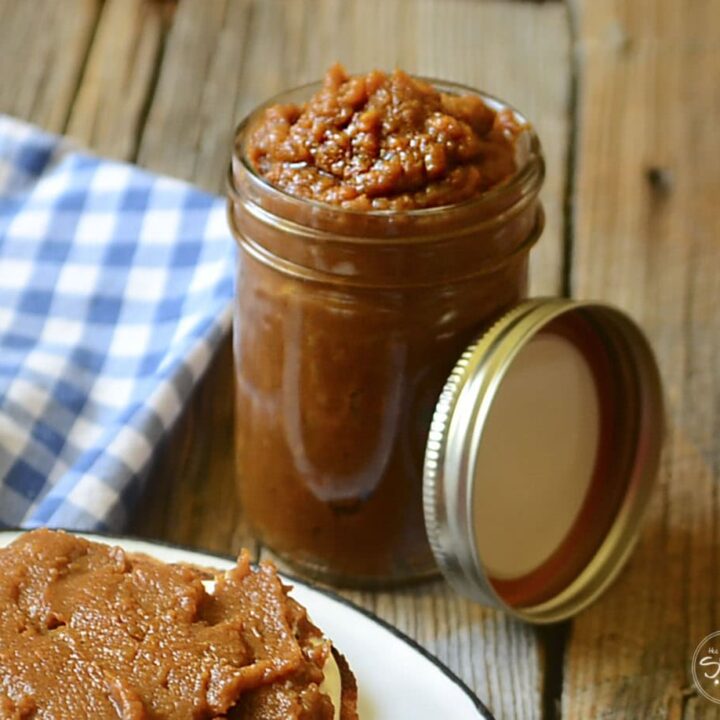 Sweet potato butter in a mason jar on a wood table.