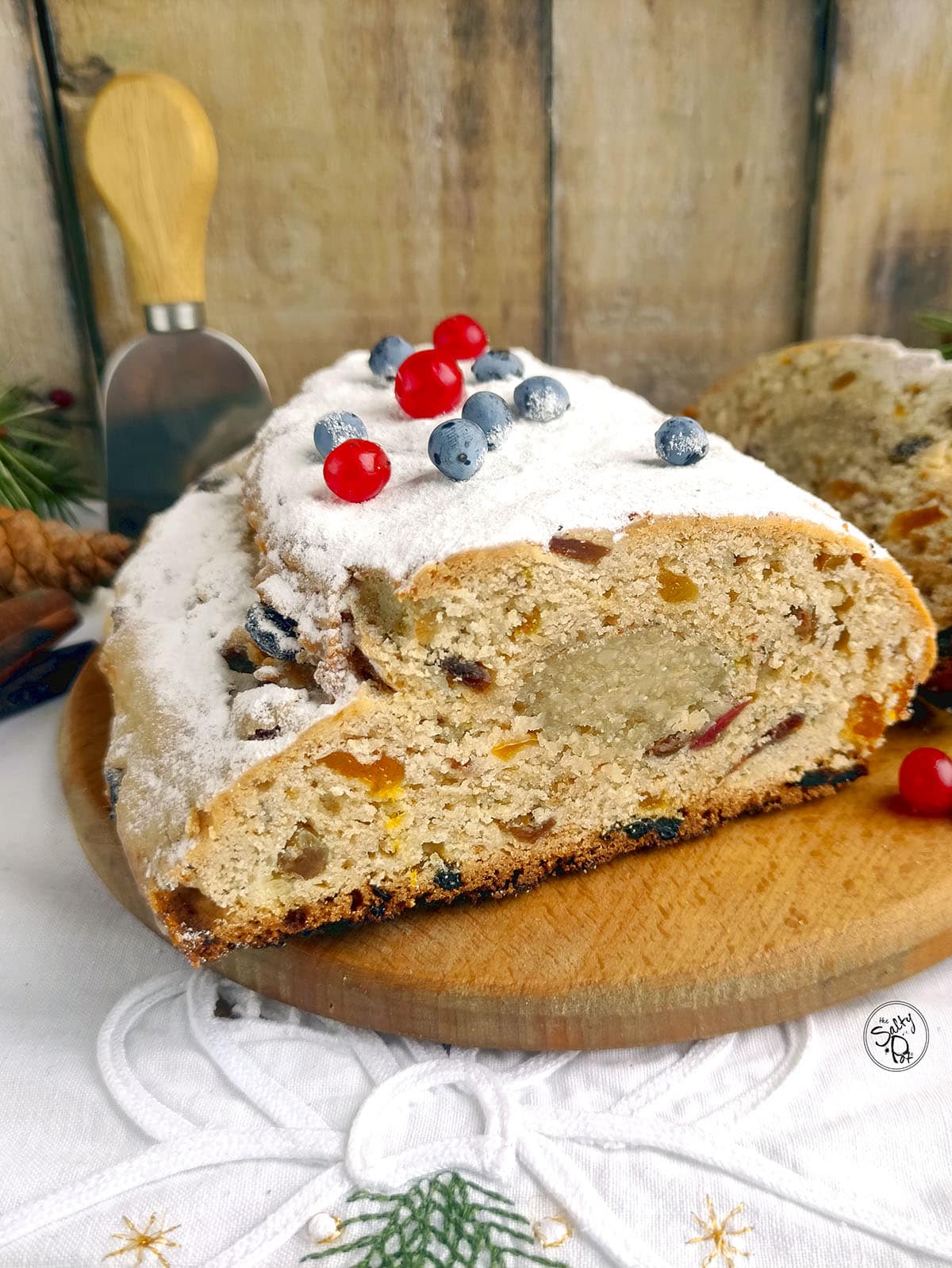 Christmas stollen on a wooden cutting board.