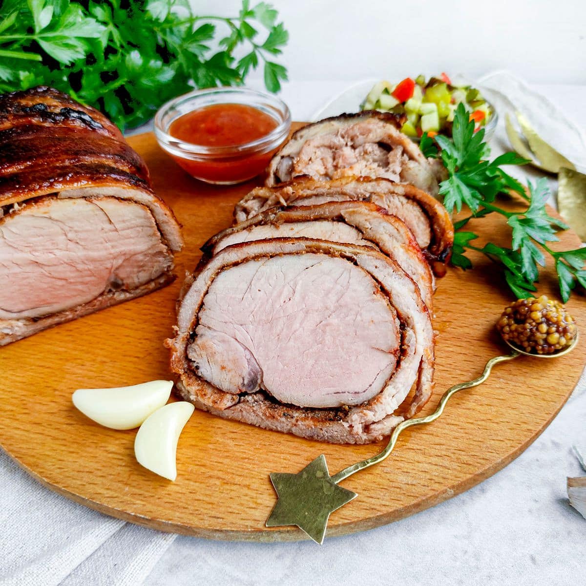 Image of Air Fryer bacon wrapped pork loin on a wooden board