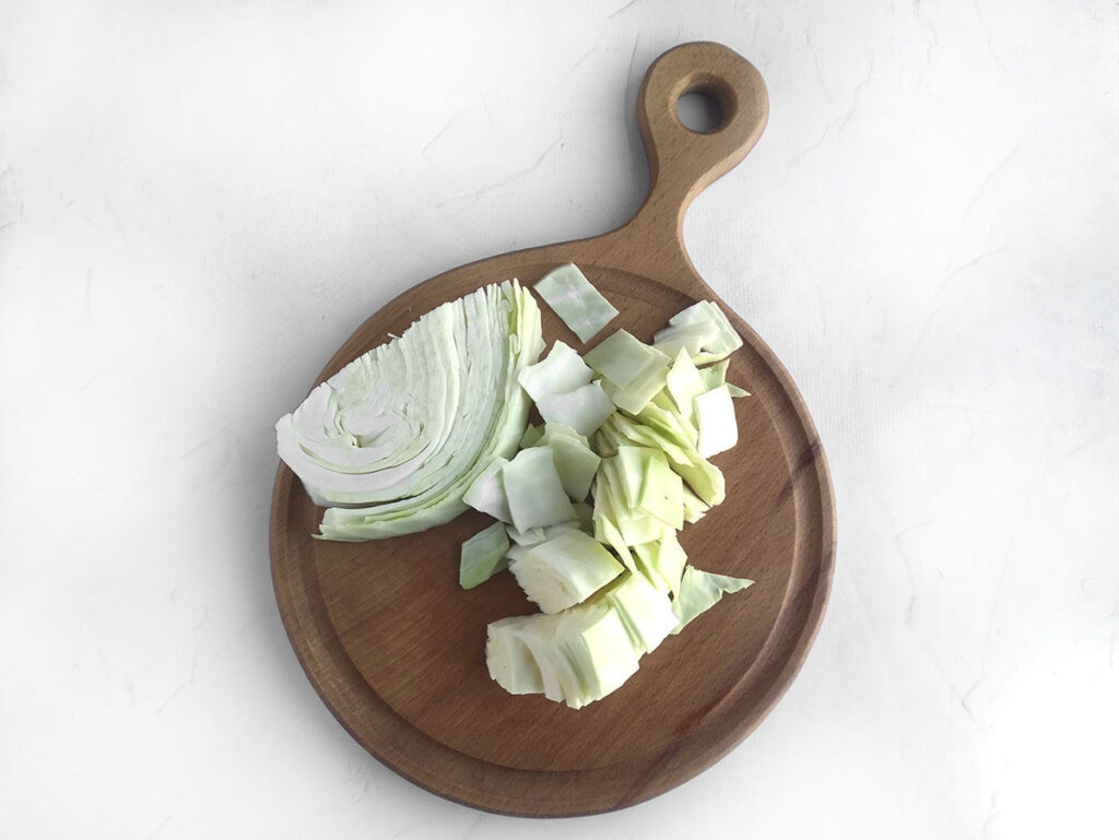 chopped cabbage in wooden chopping board