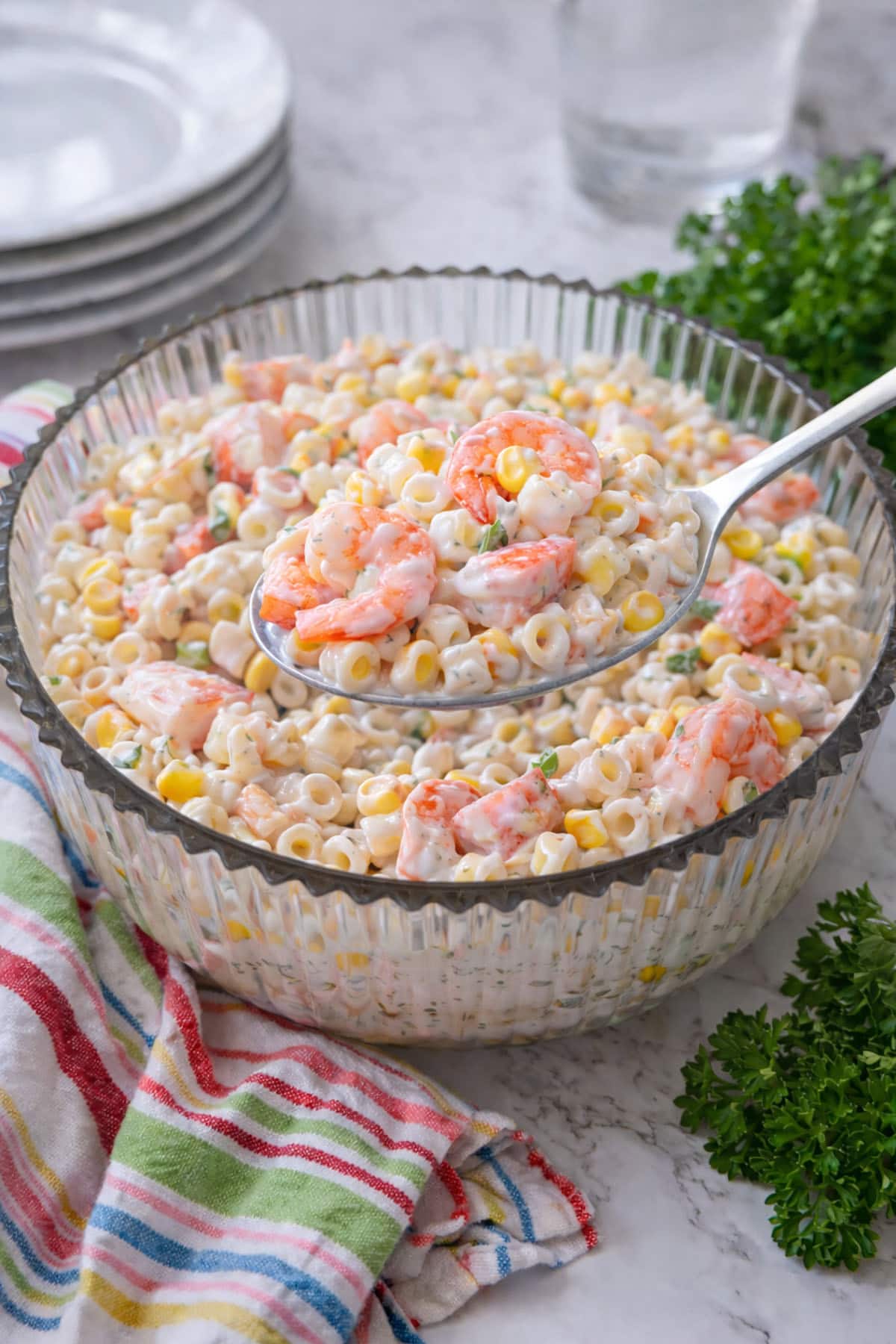 Seafood salad in a bowl with a spoon over top.