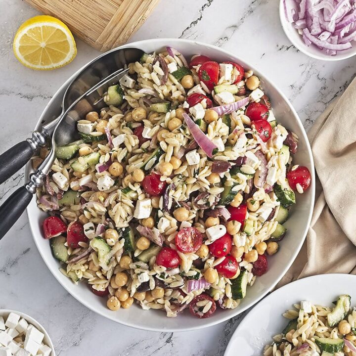 Chickpea orzo salad with feta in a bowl feature image.