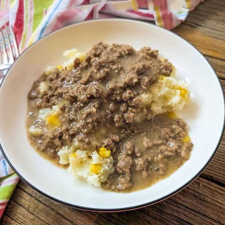 Old fashioned hamburger gravy in a white dish, square image.