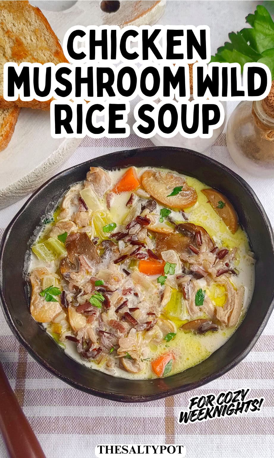 Close-up of a rustic black bowl filled with creamy chicken and wild rice soup.