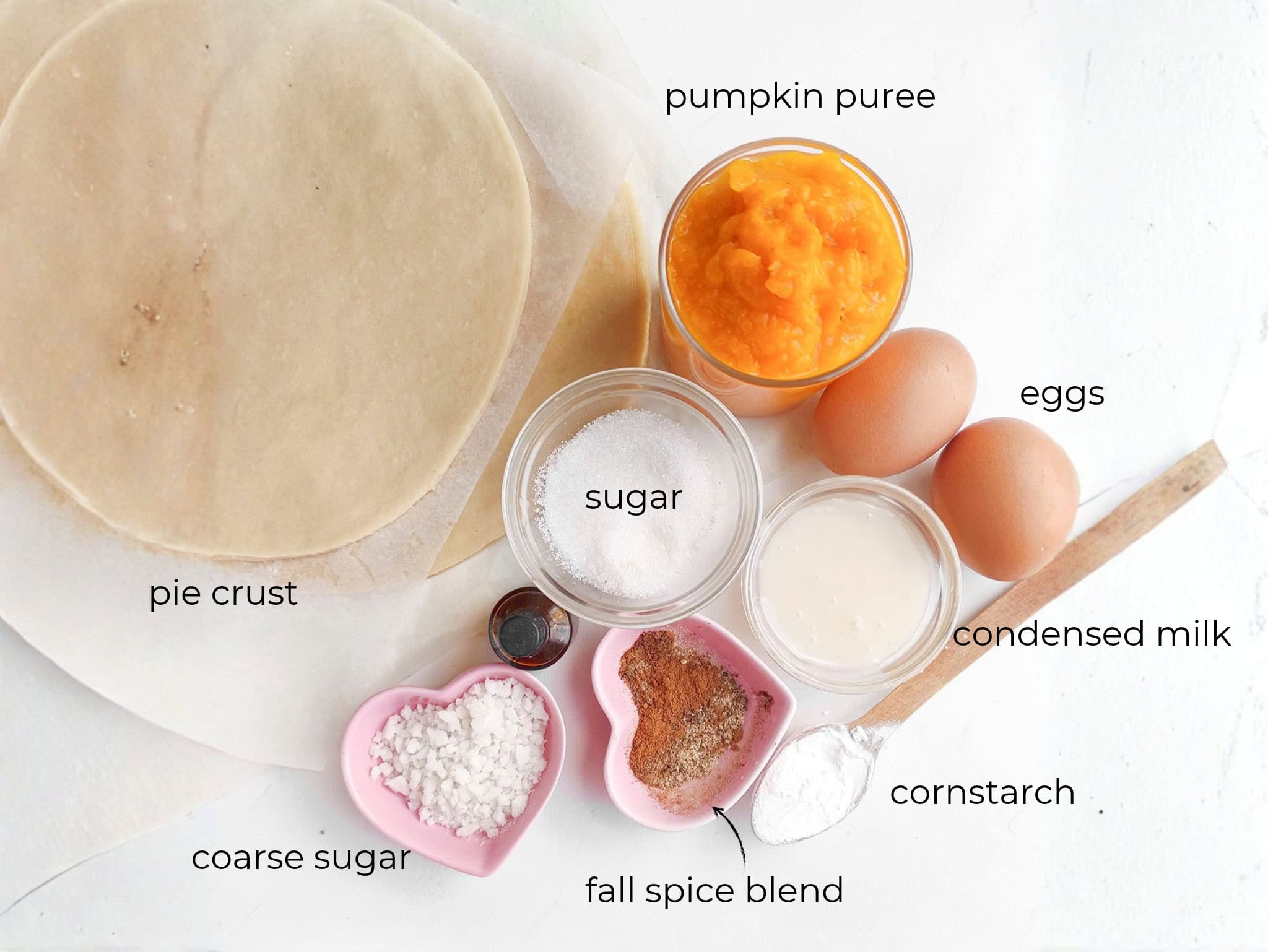 Prepped baking ingredients including round dough sheets, orange purée, eggs, milk, sugar, and spices
