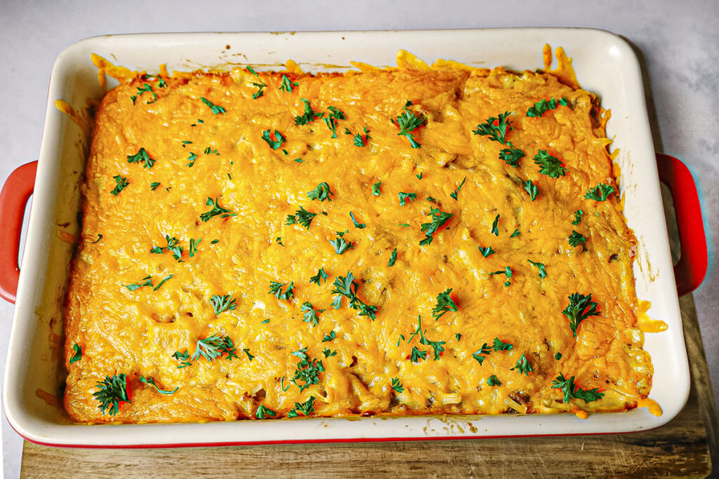 After the casserole has come out of the oven. Sprinkled over top is fresh parsely.